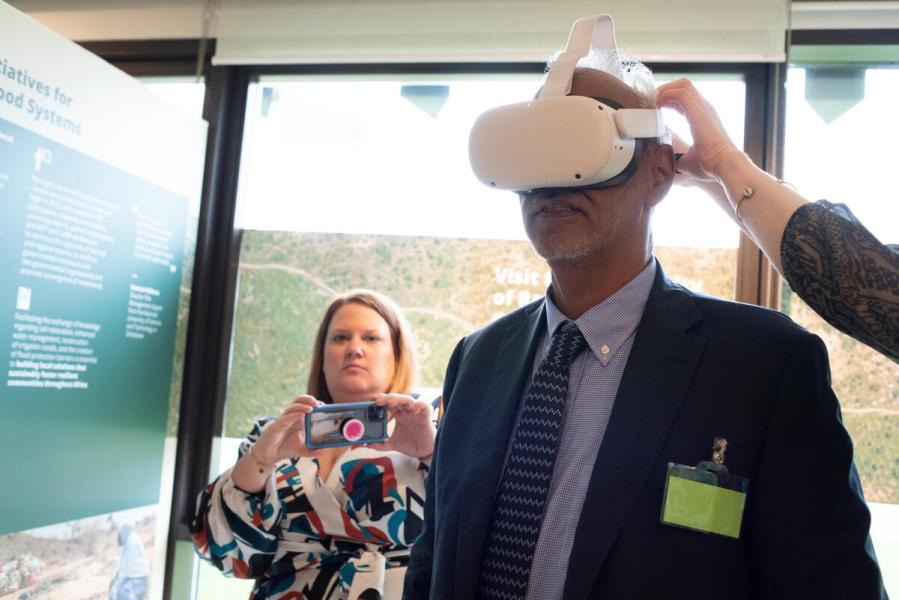 Exhibition opening: A Green Wall Against Hunger: Partnerships for Resilience Building to Decrease Humanitarian Needs. Delegates enjoy the virtual reality experience offered at the exhibition. Photo credit: WFP/Daria Addabbo