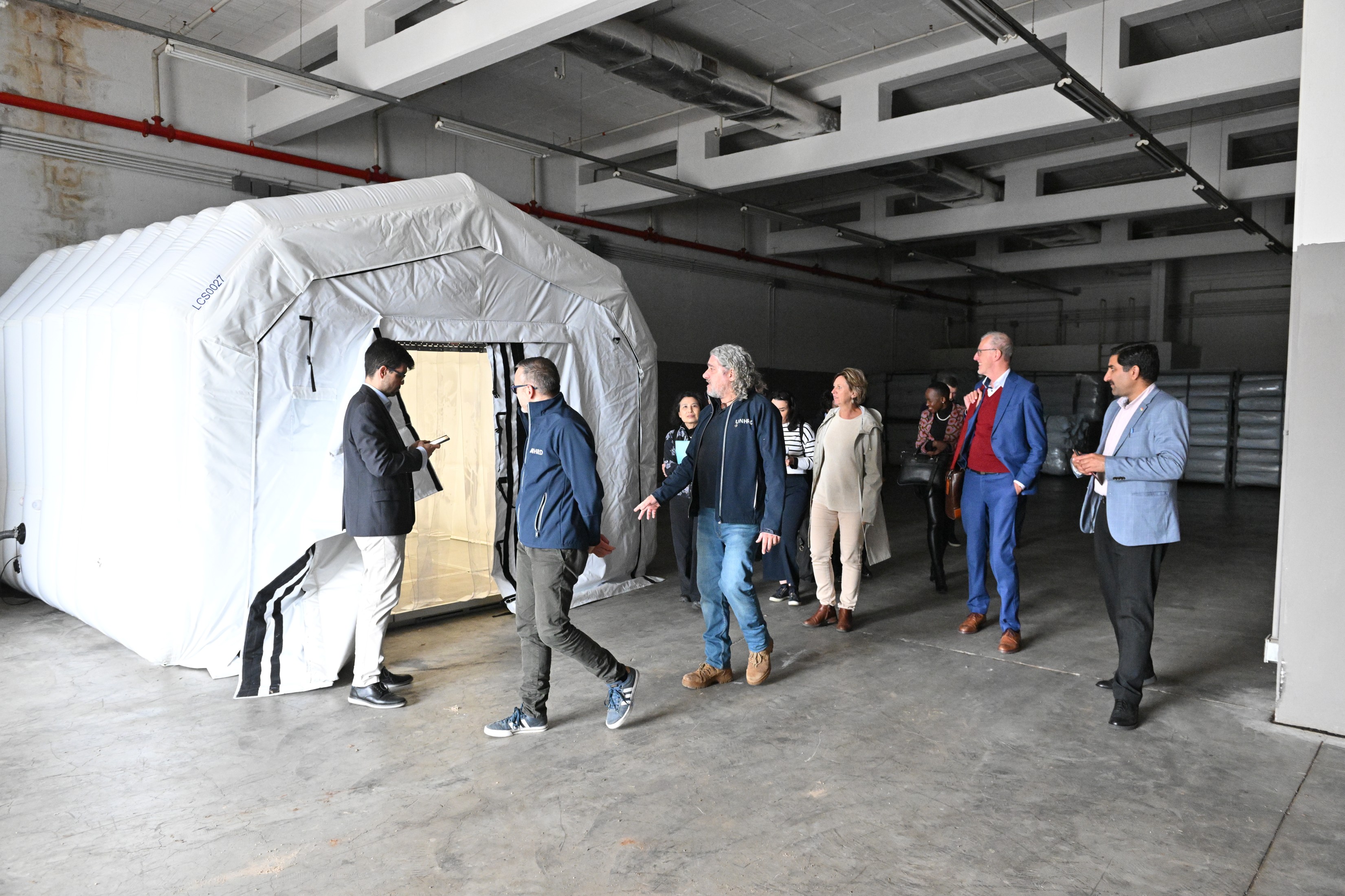 Figure 6: A quick stop enroute to the training and simulation site to examine the “fridge tent”, a UNHRD Lab innovation that allows for the storage of critical supplies such as medicines and health kits 